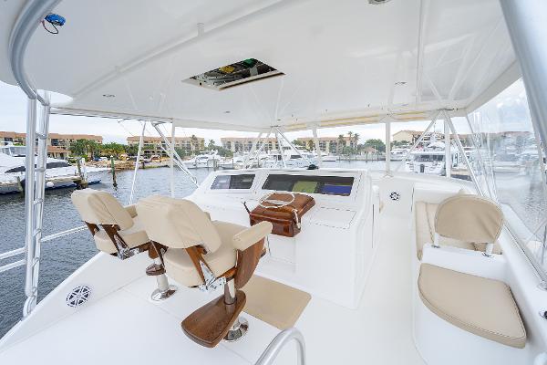 Slide: The Image of 2005 Viking 61 yacht helm with beige seating and marina view. - 7