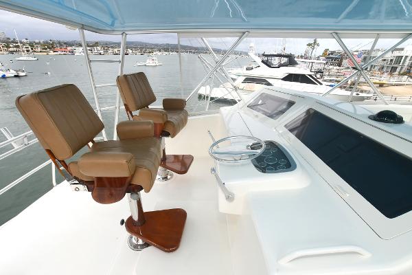 Slide: The Image of Flybridge of a 2000 Viking 65 Convertible yacht with two captain's chairs. - 11