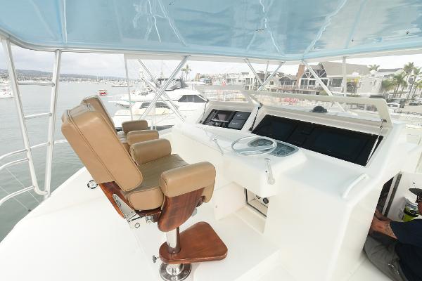 Slide: The Image of 2000 Viking 65 Convertible yacht helm station with leather seats and modern controls. - 12
