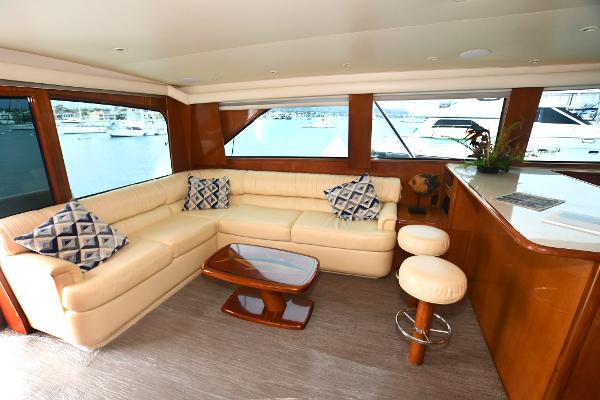 Slide: The Image of Luxurious interior of 2000 Viking 65 Convertible yacht with cream leather seating and wooden accents. - 15