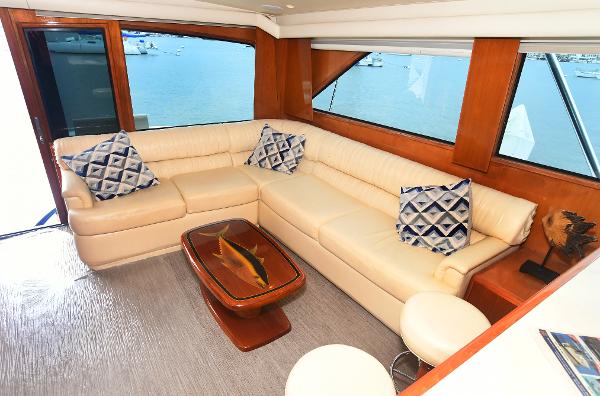 Slide: The Image of Luxurious interior of 2000 Viking 65 Convertible yacht with cream leather sofa and ocean view. - 16