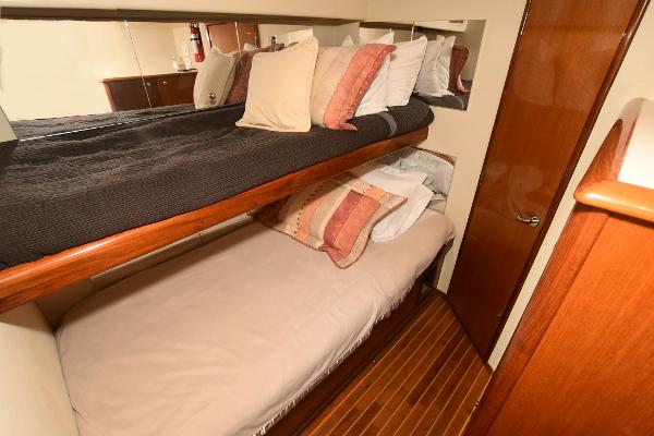 Slide: The Image of Bunk beds in the 2000 Viking 65 Convertible yacht cabin. - 17