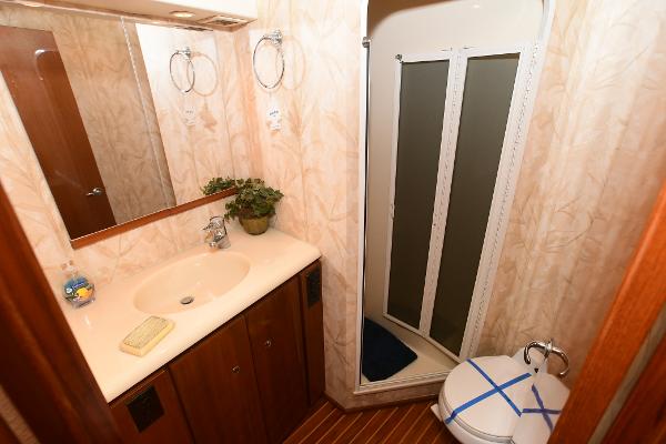 Slide: The Image of Bathroom interior of a 2000 Viking 65 Convertible yacht with sink, shower, and toilet. - 34