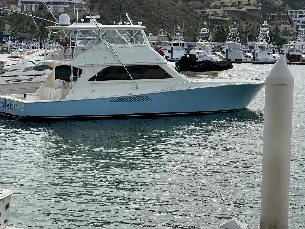 Slide: The Image of 2000 Viking 65 Convertible yacht docked in a marina, side view. - 5