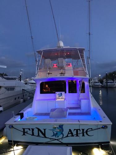 Slide: The Image of Viking 65 Convertible 2000 yacht "Finatic" docked with blue lights at dusk. - 7