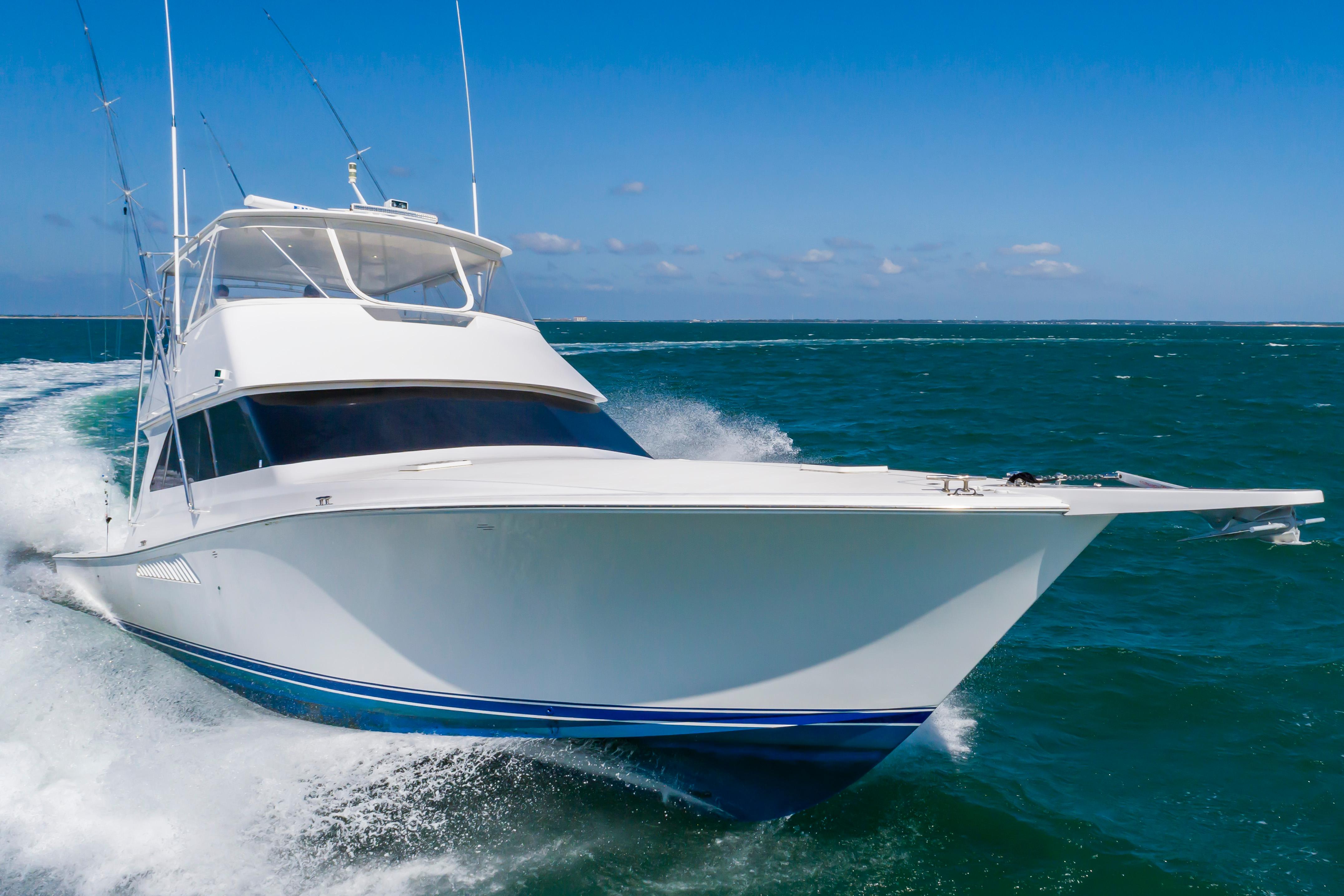Slide: The Image of 1998 Viking Convertible yacht cruising on open water. - 0