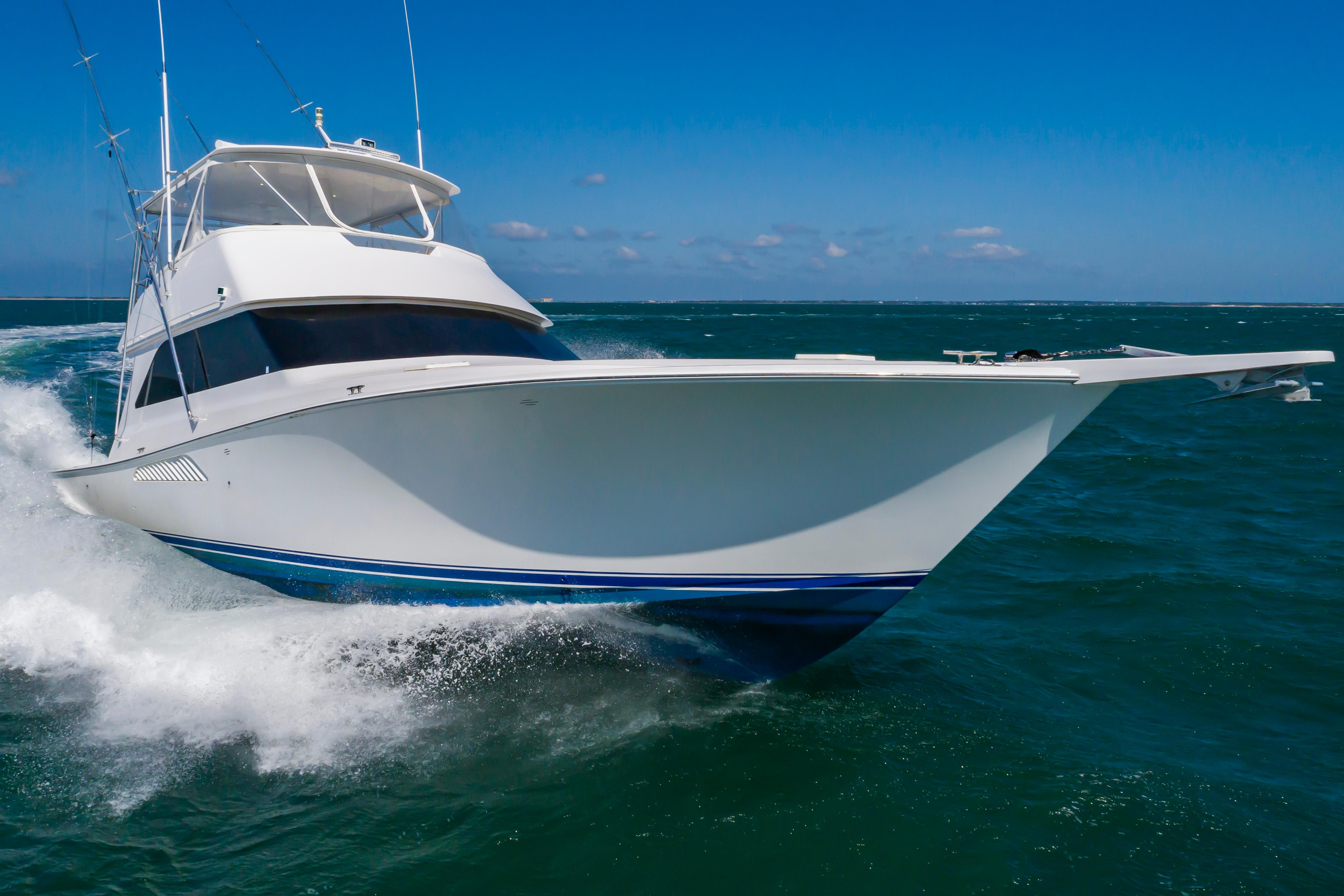 Slide: The Image of 1998 Viking Convertible yacht cruising on open water. - 1