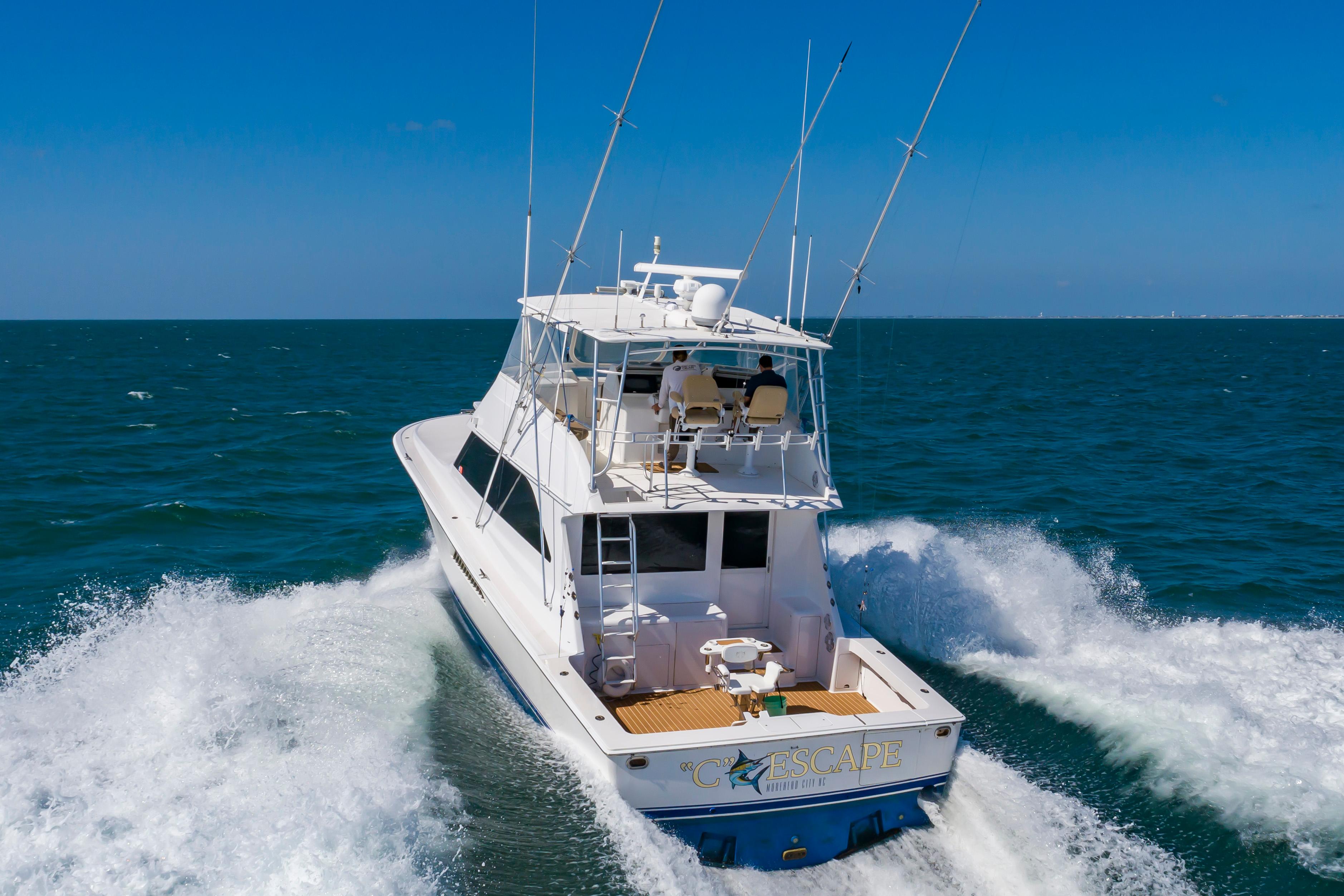 Slide: The Image of 1998 Viking Convertible yacht cruising on open sea under clear blue sky. - 10
