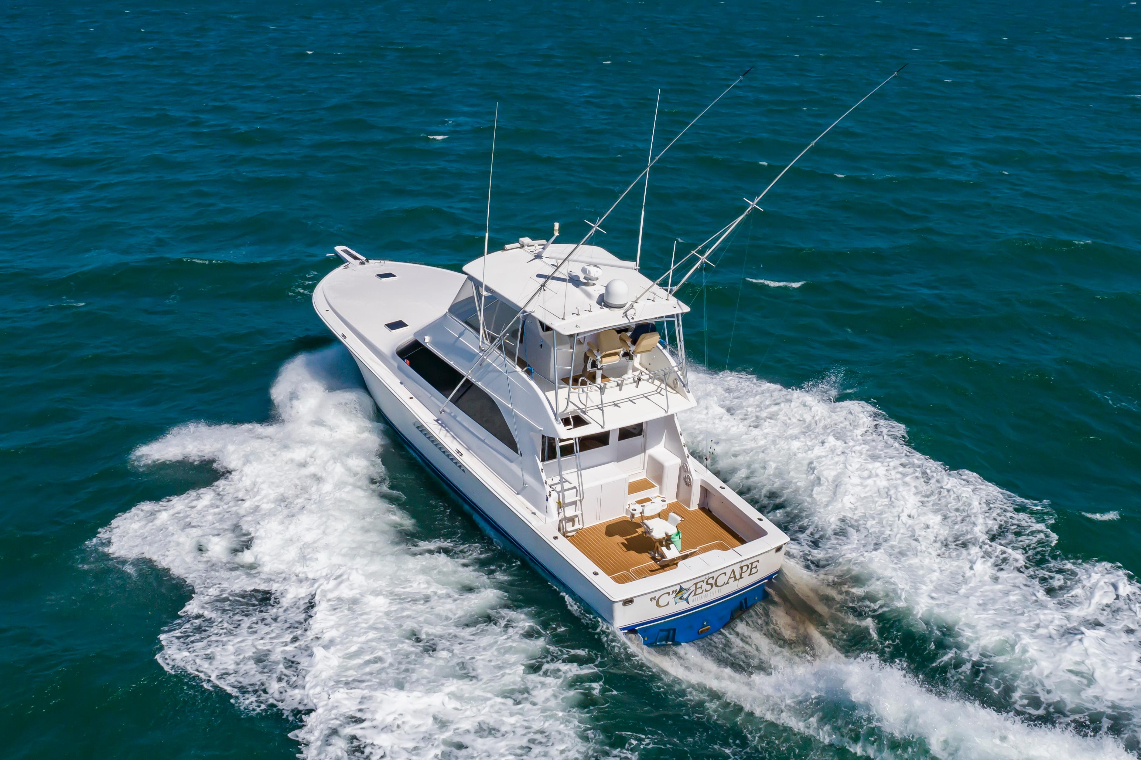 Slide: The Image of 1998 Viking Convertible boat cruising on open water. - 13