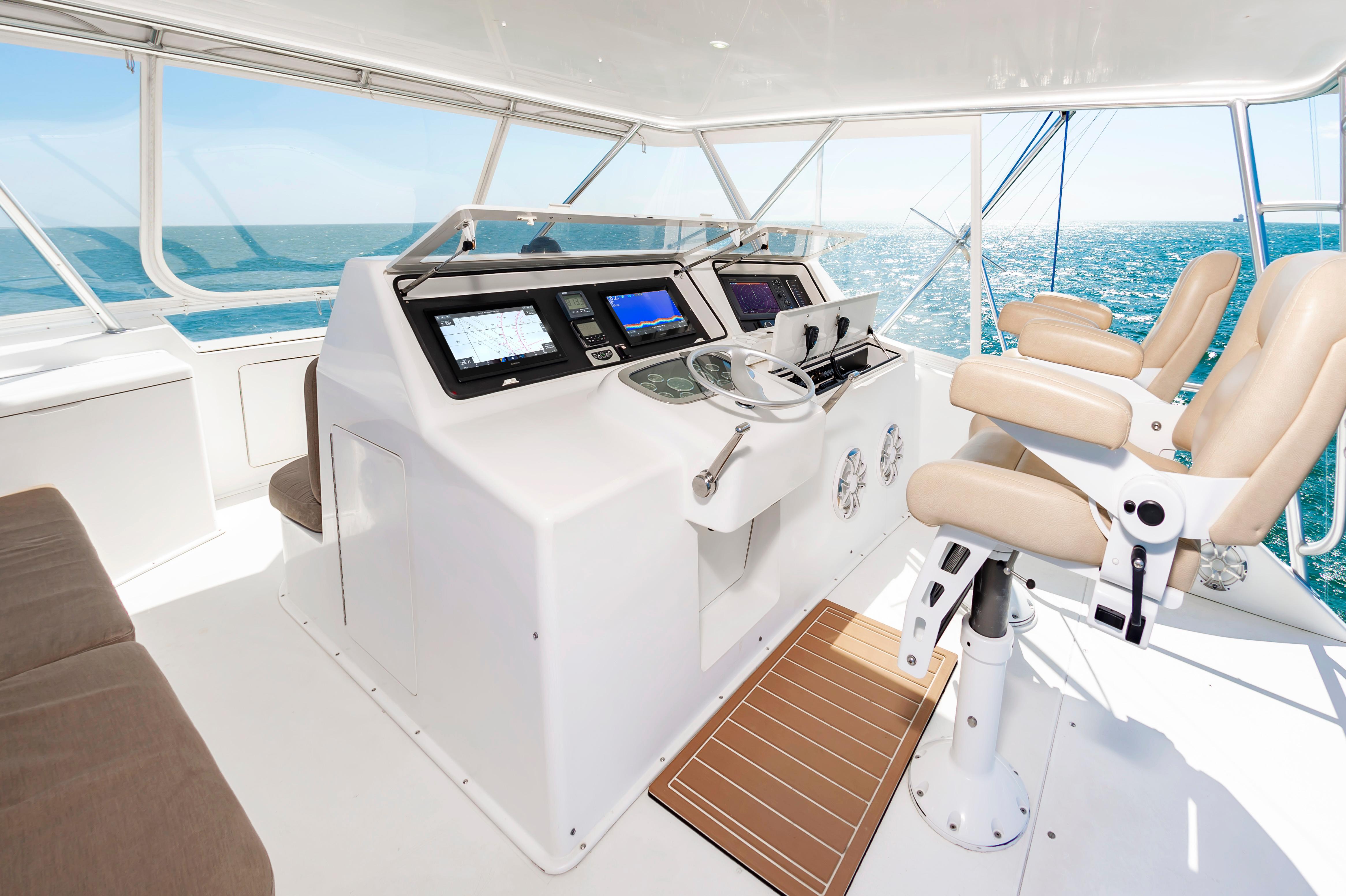 Slide: The Image of Interior helm of 1998 Viking Convertible yacht with modern navigation equipment and ocean view. - 14