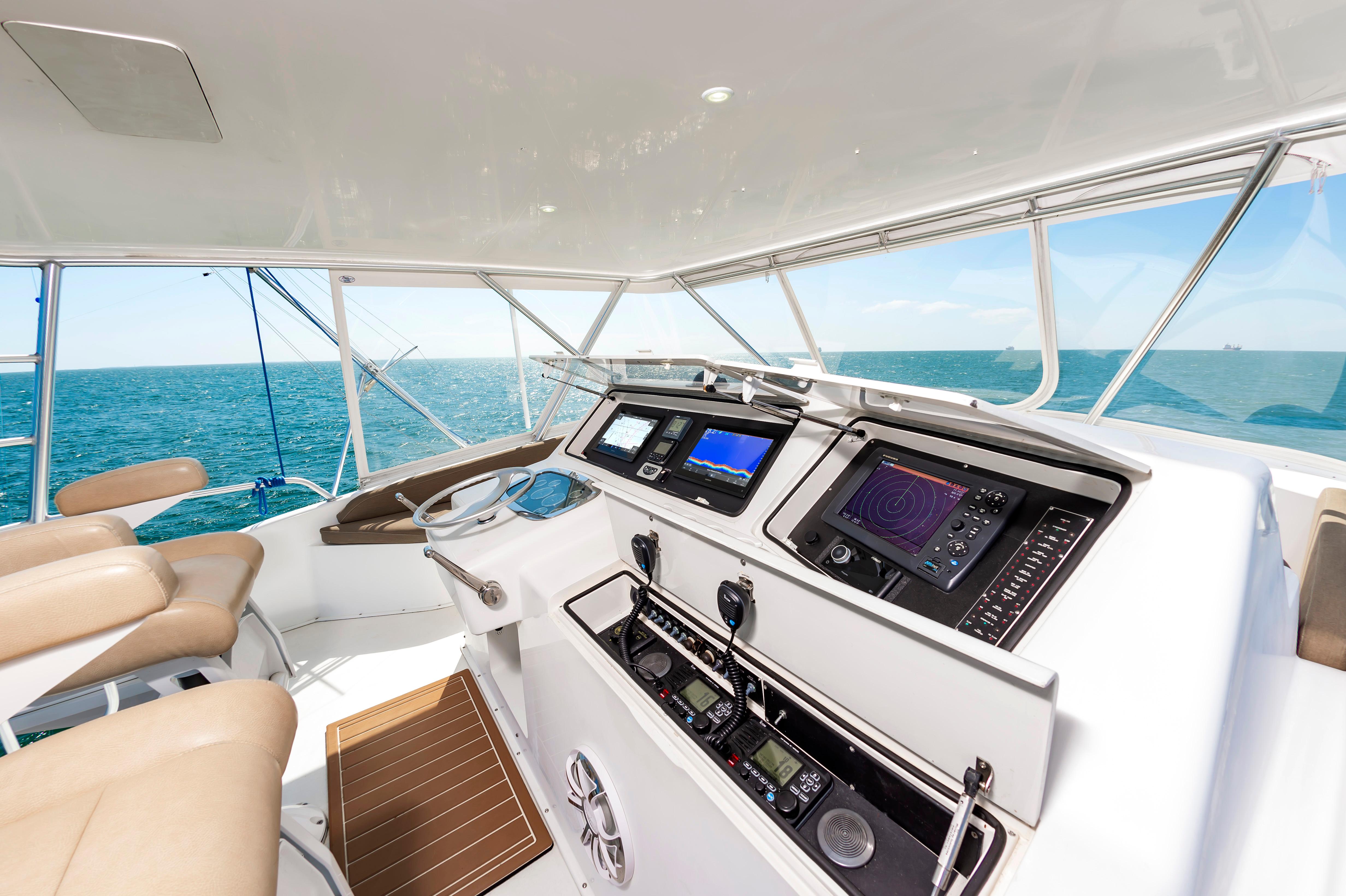 Slide: The Image of 1998 Viking Convertible yacht helm with navigation equipment and ocean view. - 15