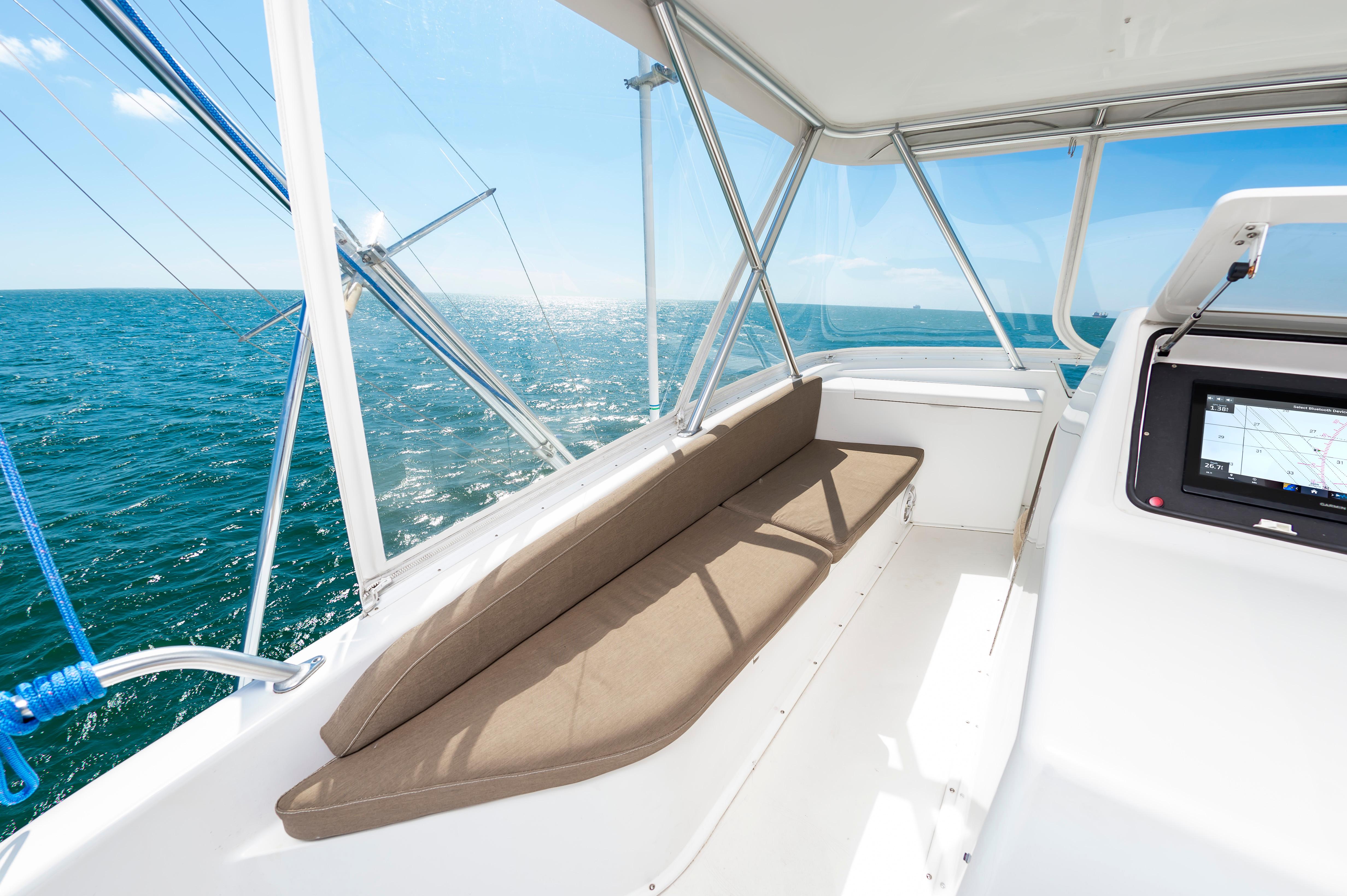 Slide: The Image of Interior view of 1998 Viking Convertible boat with ocean backdrop. - 16