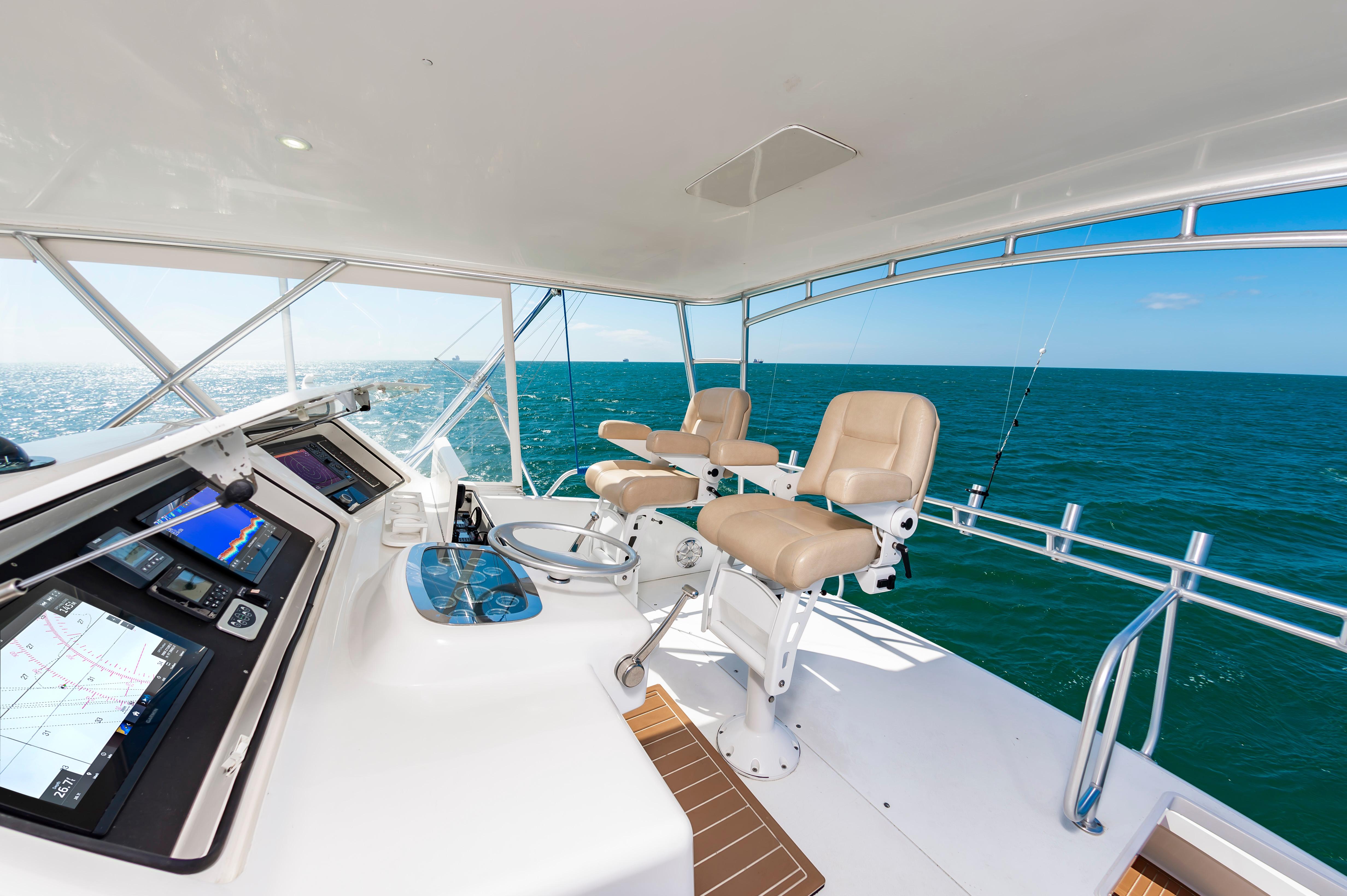 Slide: The Image of 1998 Viking Convertible yacht helm with ocean view and navigation equipment. - 19