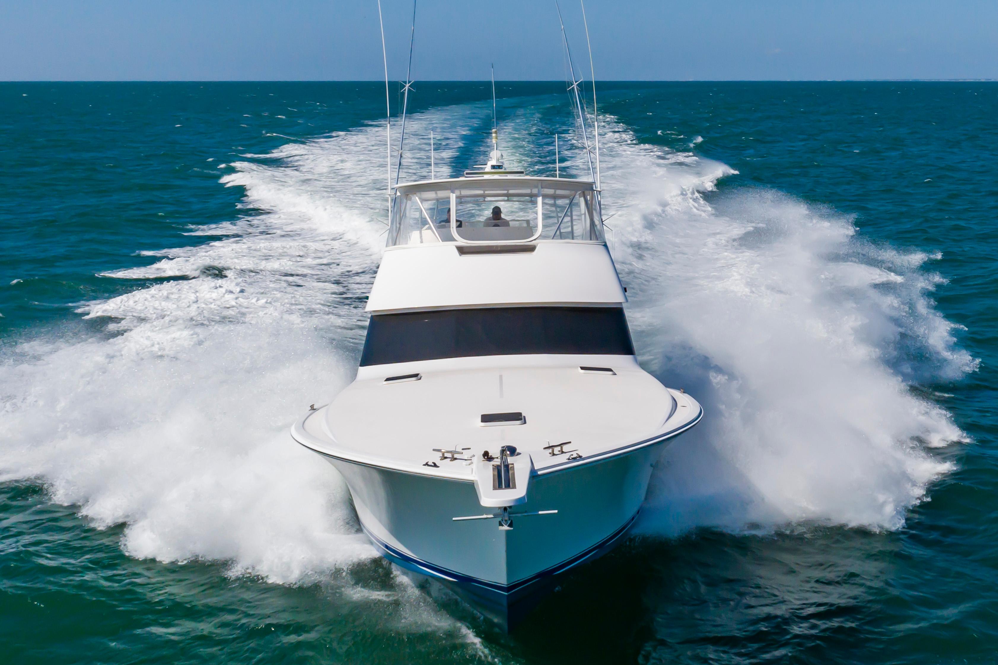 Slide: The Image of 1998 Viking Convertible yacht cruising on open water. - 2