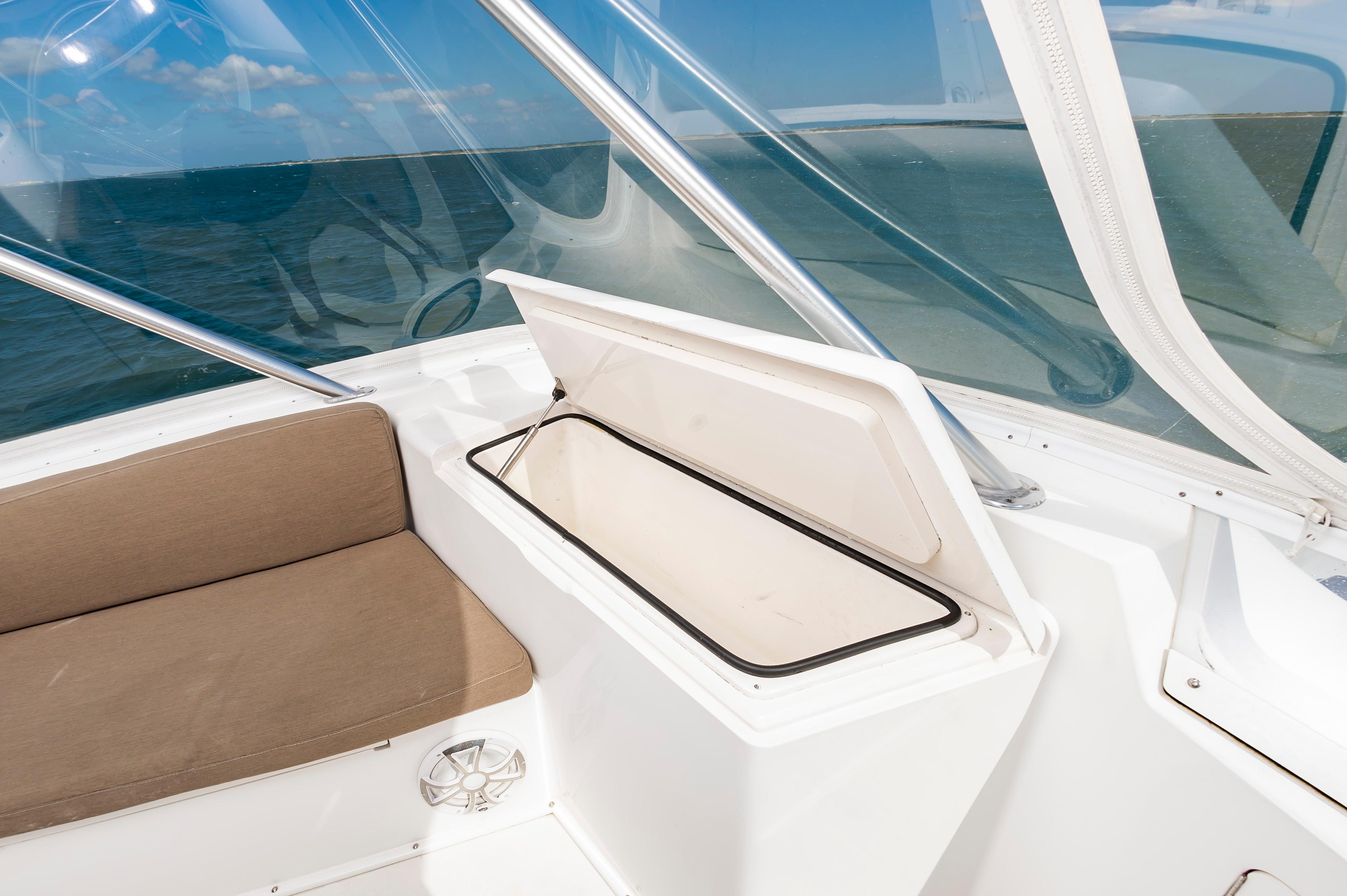 Slide: The Image of 1998 Viking Convertible boat interior with open storage compartment and cushioned seating. - 20