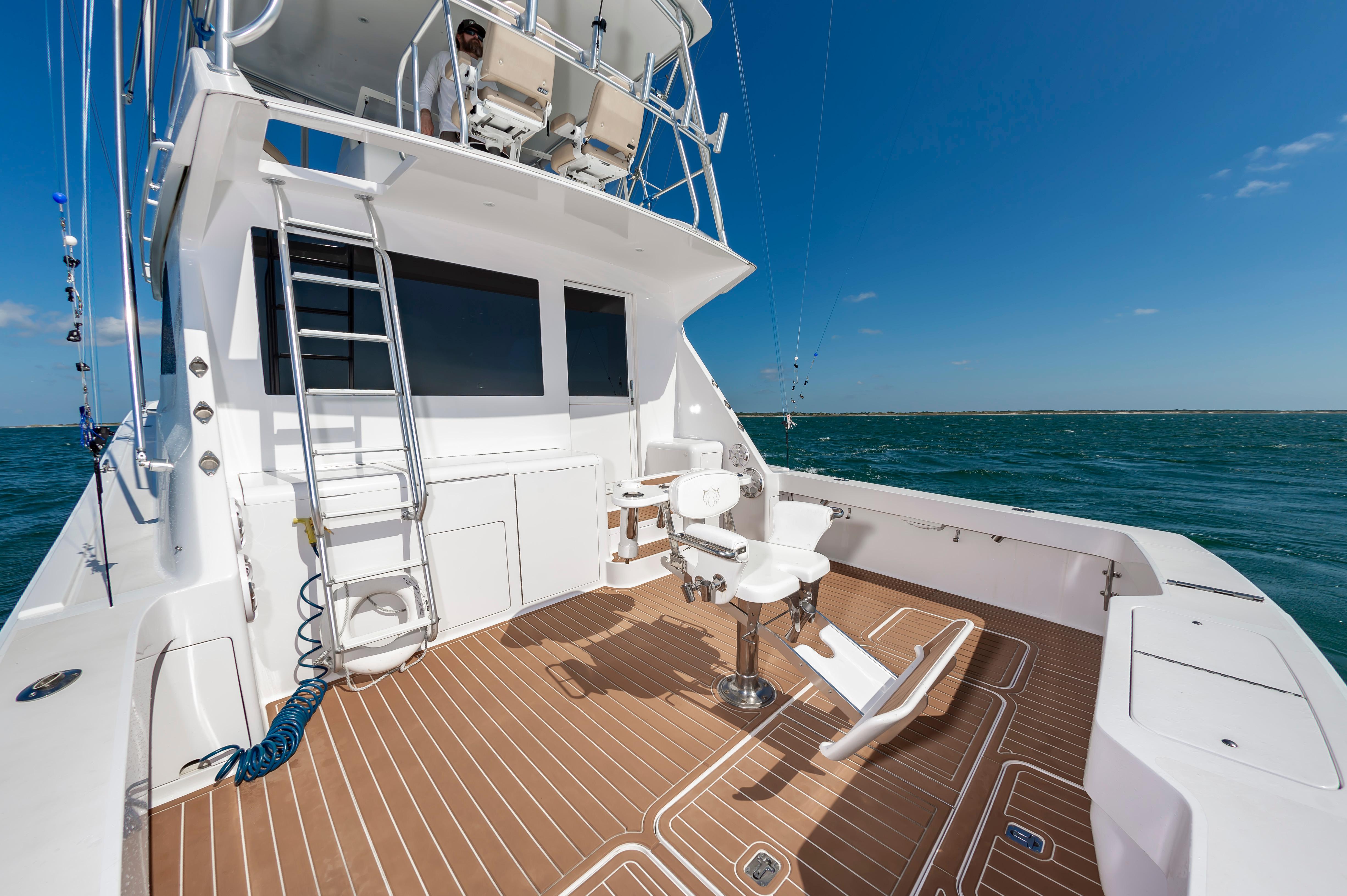 Slide: The Image of 1998 Viking Convertible boat with fishing chairs and ocean view. - 25