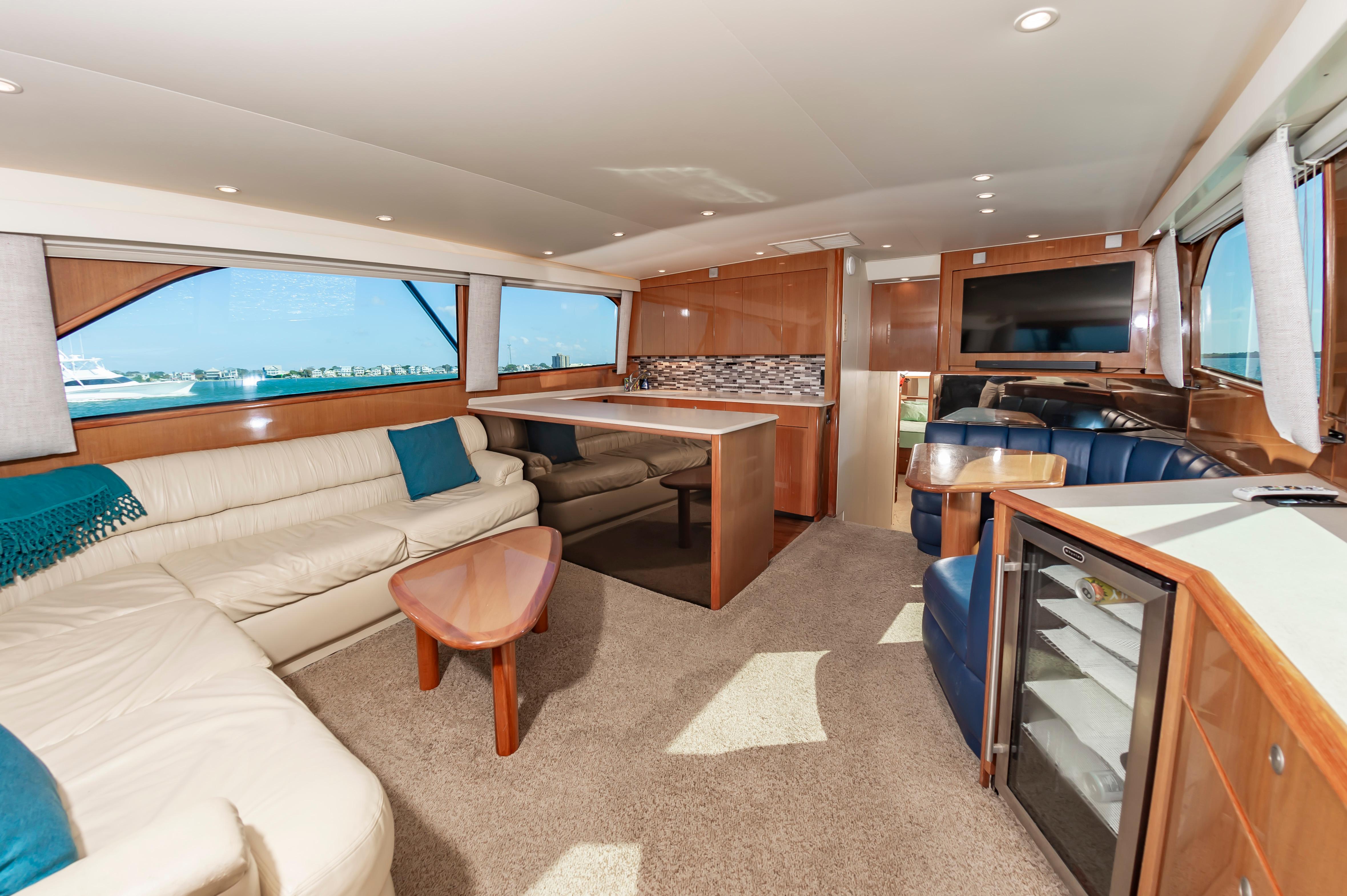 Slide: The Image of Interior of a 1998 Viking Convertible yacht with modern furnishings and large windows. - 30