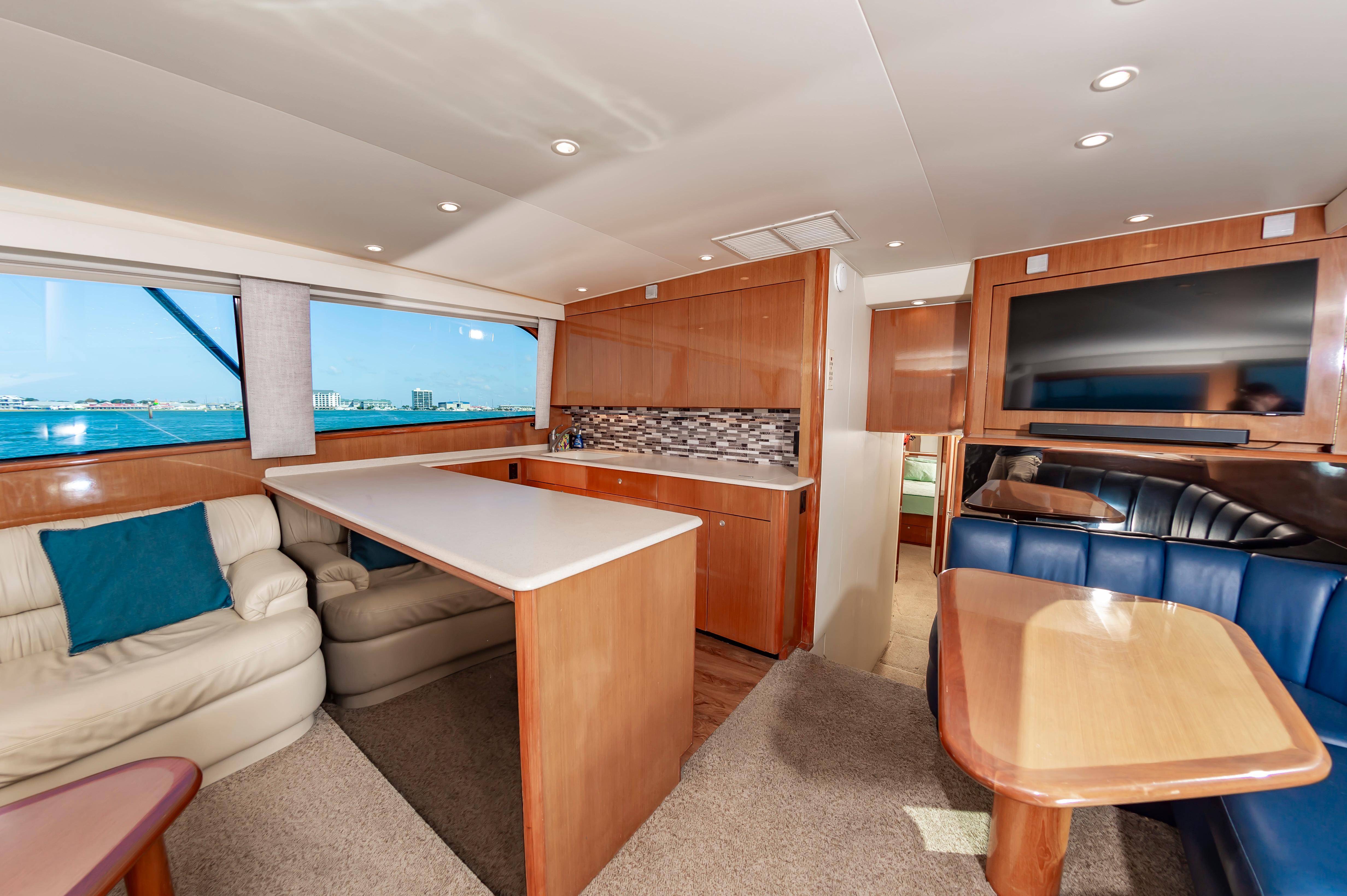 Slide: The Image of Interior of a 1998 Viking Convertible yacht with modern kitchen and seating area. - 32