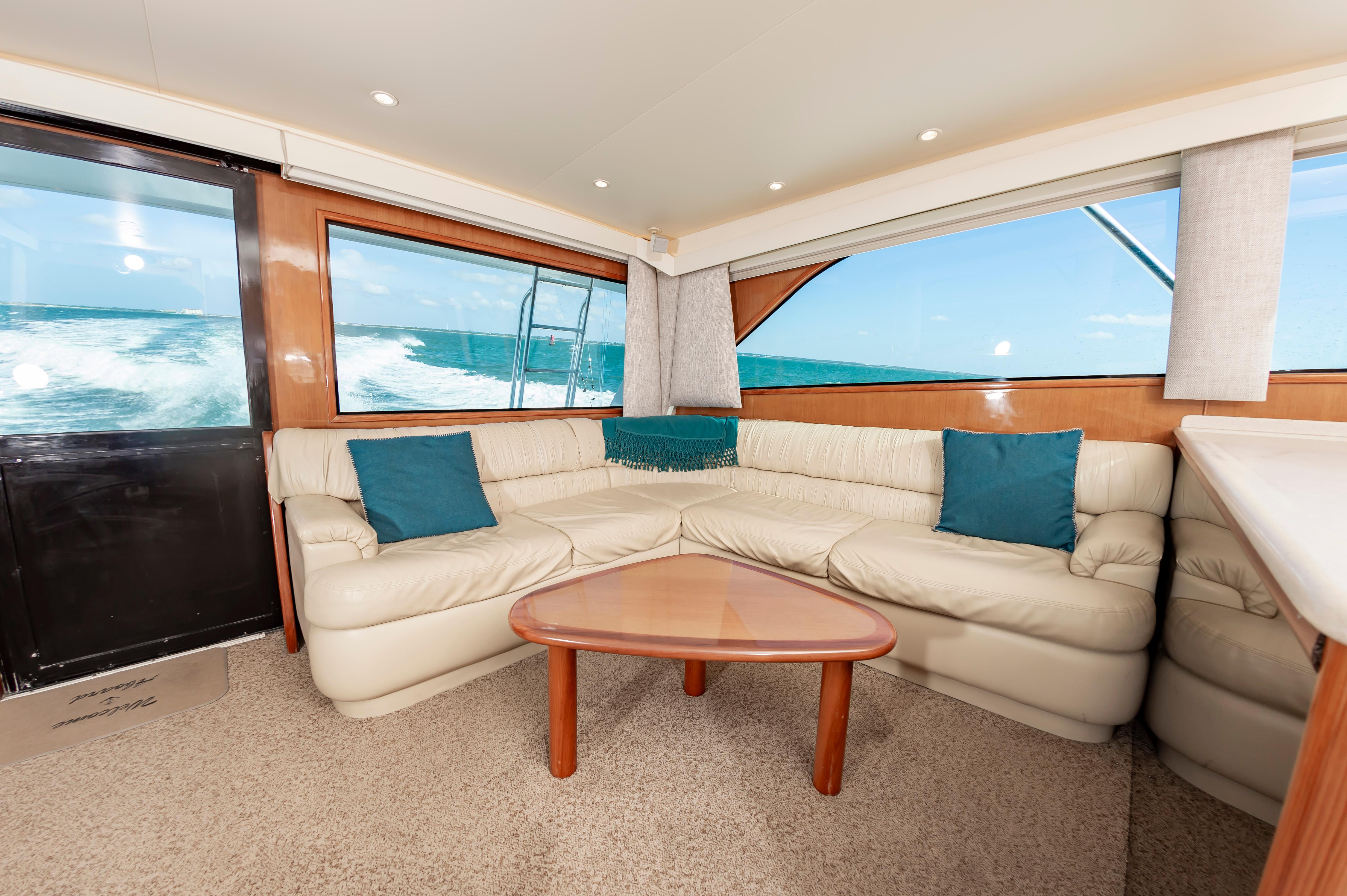 Slide: The Image of Interior of 1998 Viking Convertible yacht with beige leather seating and ocean view. - 33