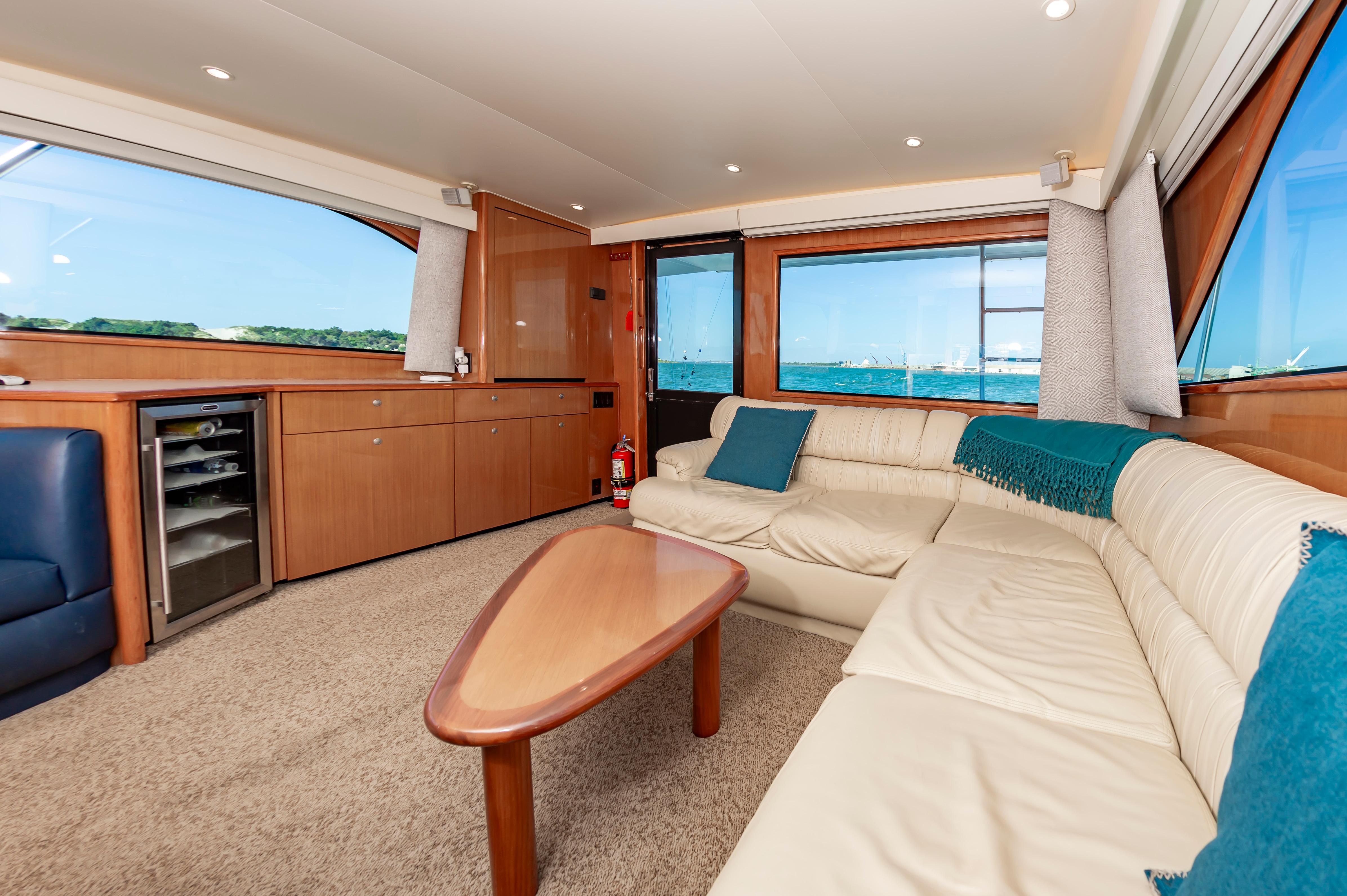 Slide: The Image of Luxurious interior of a 1998 Viking Convertible yacht with cream leather seating and ocean view. - 38