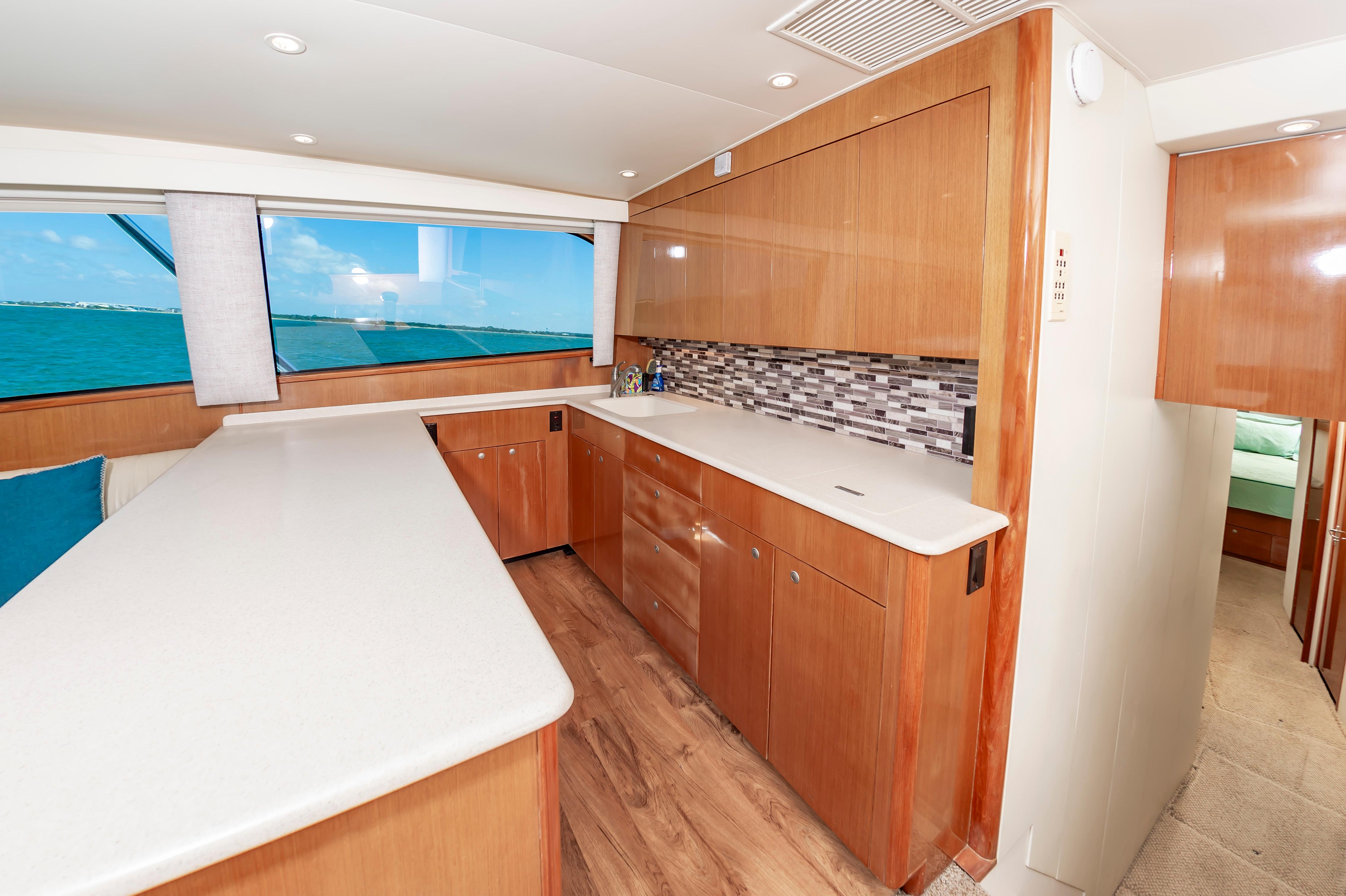 Slide: The Image of 1998 Viking Convertible yacht kitchen with modern wood cabinetry and ocean view. - 39