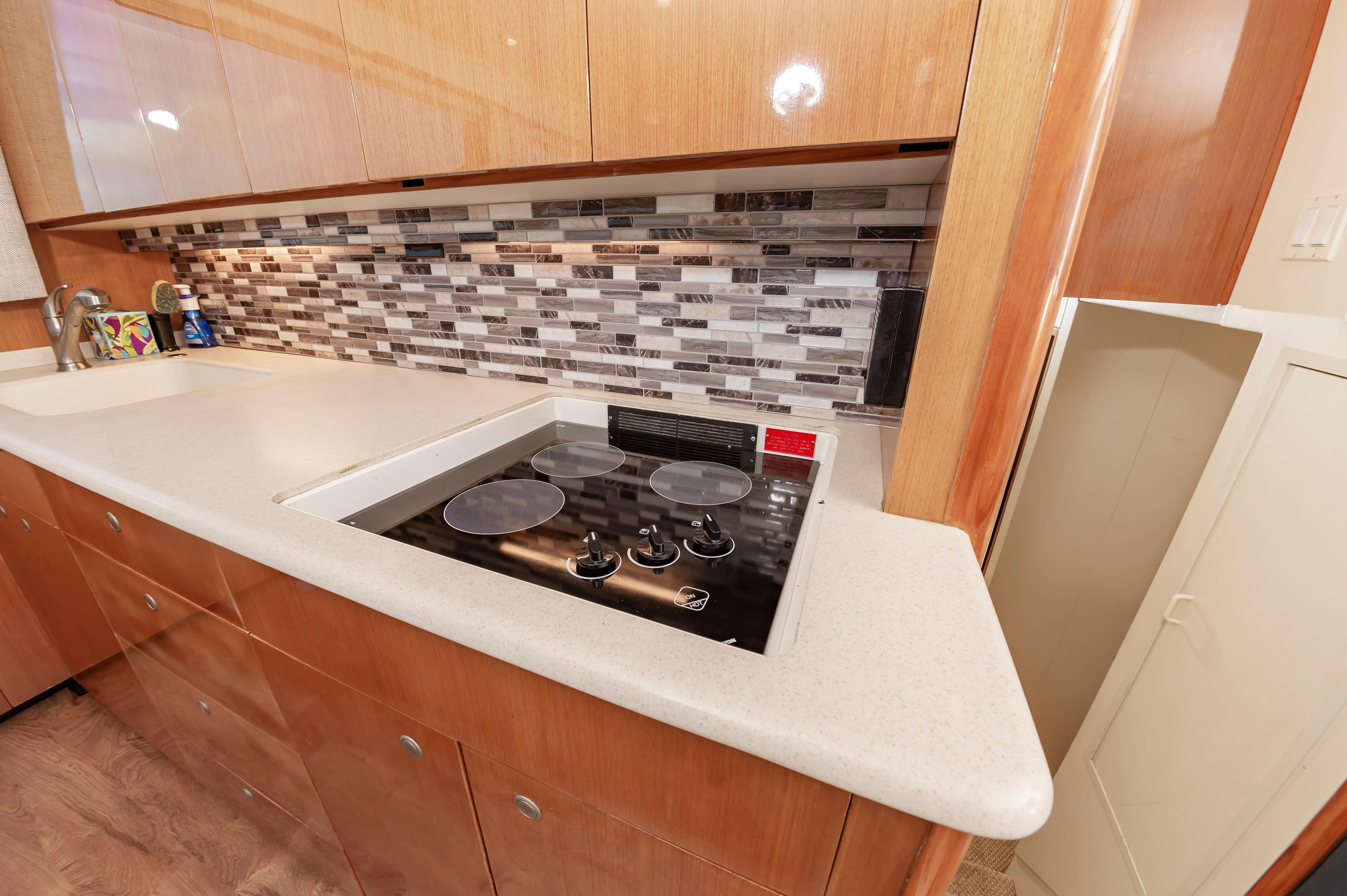 Slide: The Image of Modern kitchen in a 1998 Viking Convertible with electric stove and mosaic tile backsplash. - 40