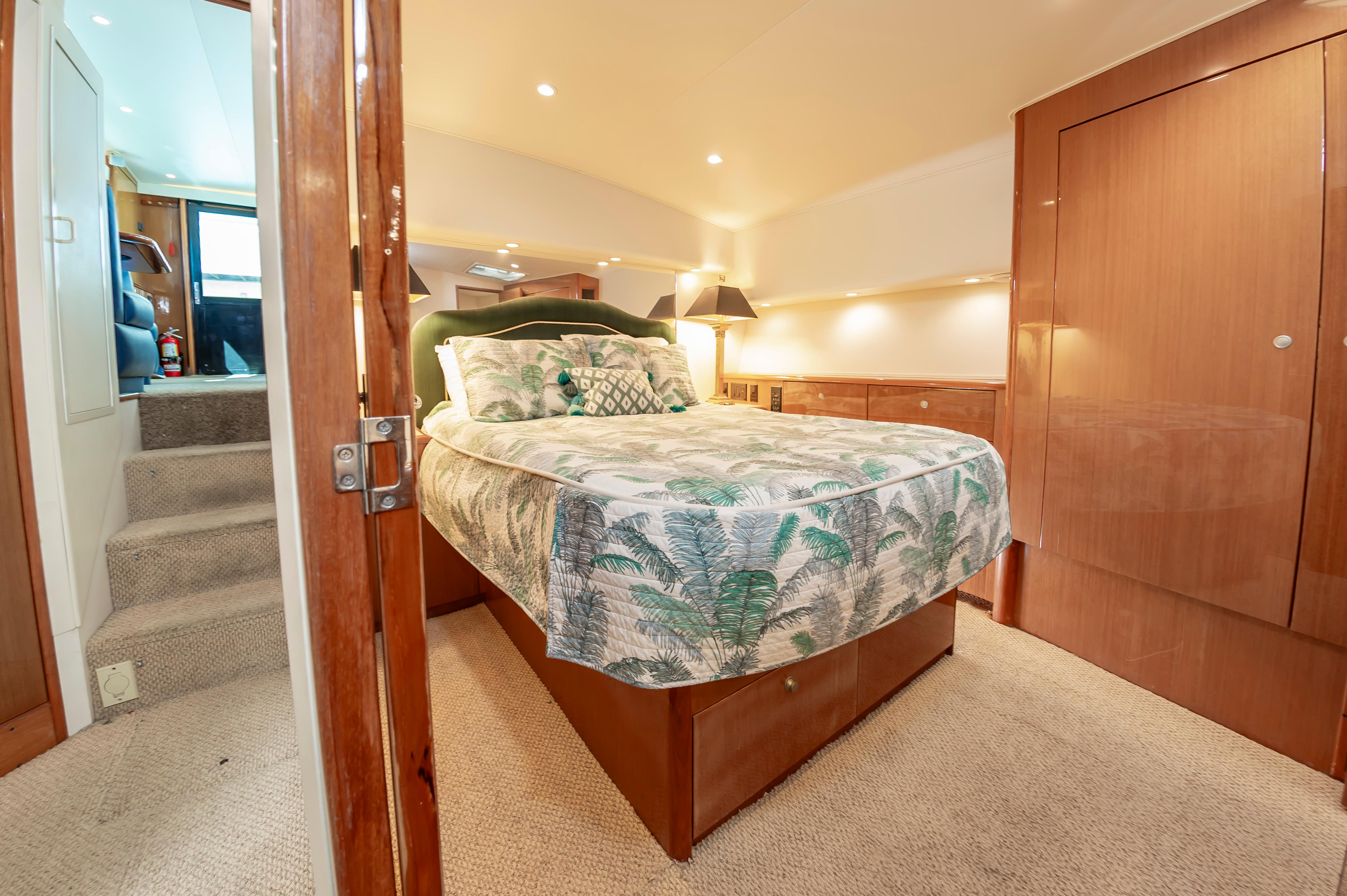 Slide: The Image of Luxurious bedroom interior of a 1998 Viking Convertible yacht with a cozy bed and elegant decor. - 42