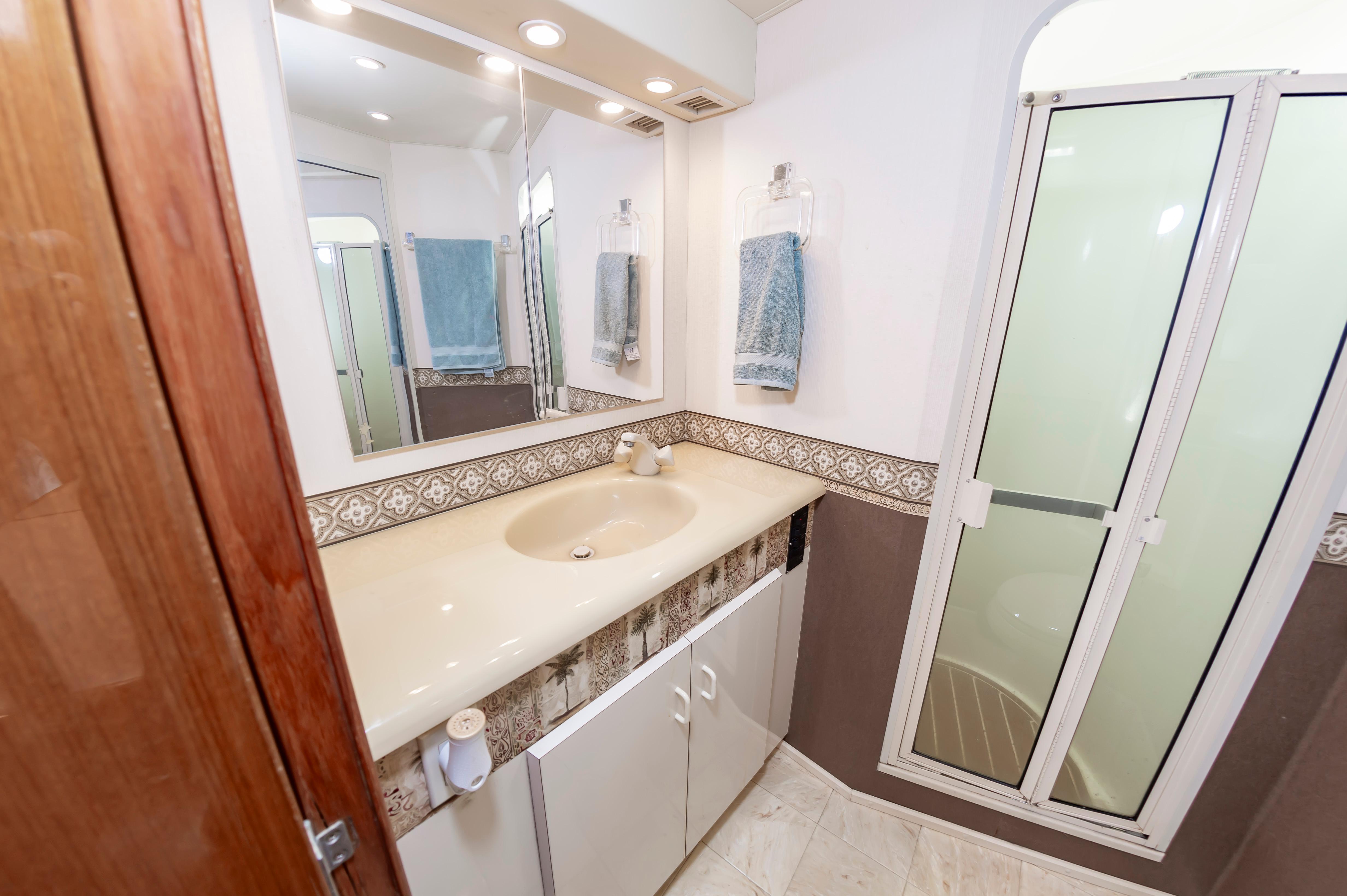 Slide: The Image of 1998 Viking Convertible bathroom with sink, mirror, and shower. - 46