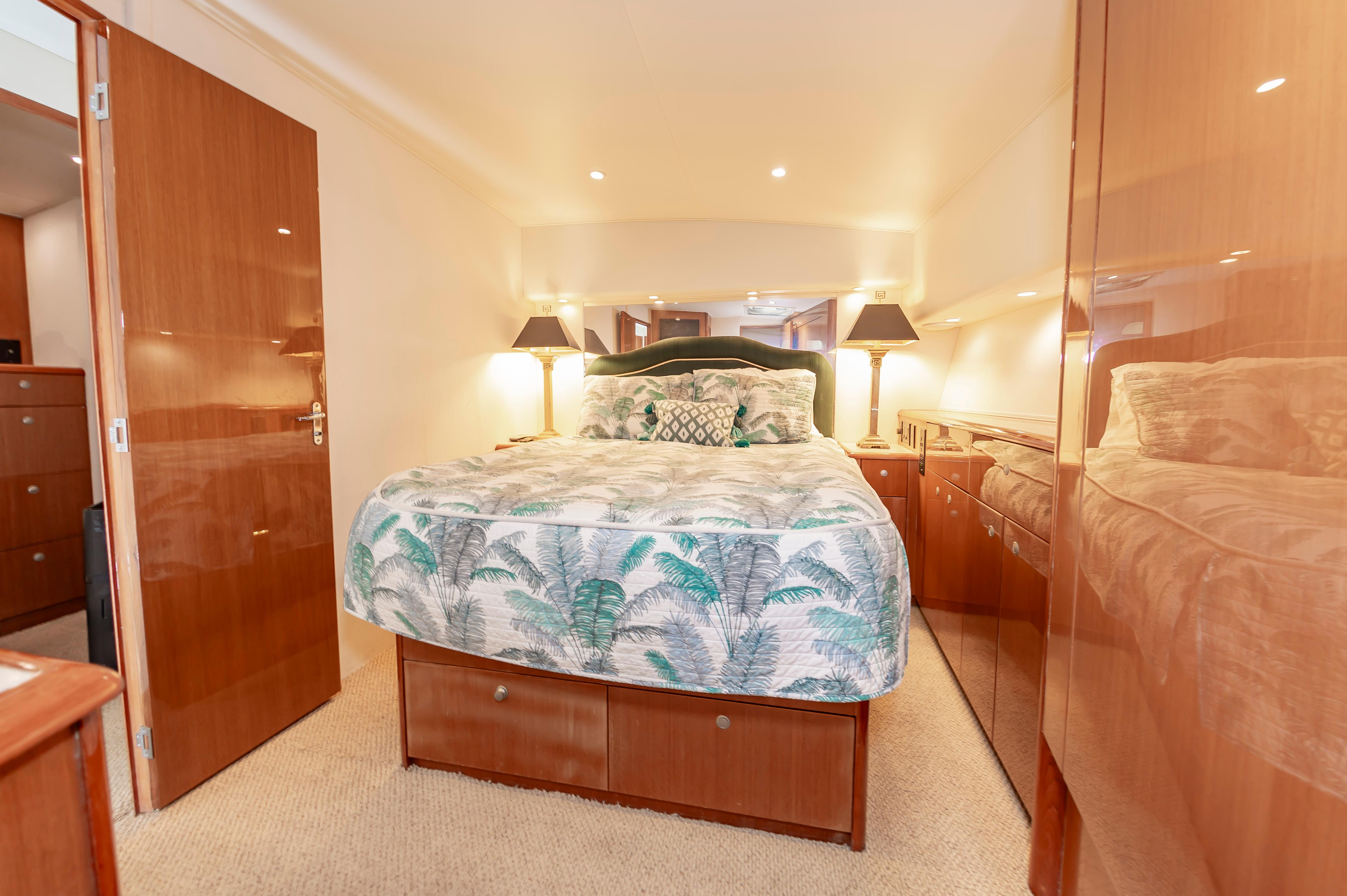 Slide: The Image of Luxurious bedroom interior of a 1998 Viking Convertible yacht with elegant wood finishes. - 49