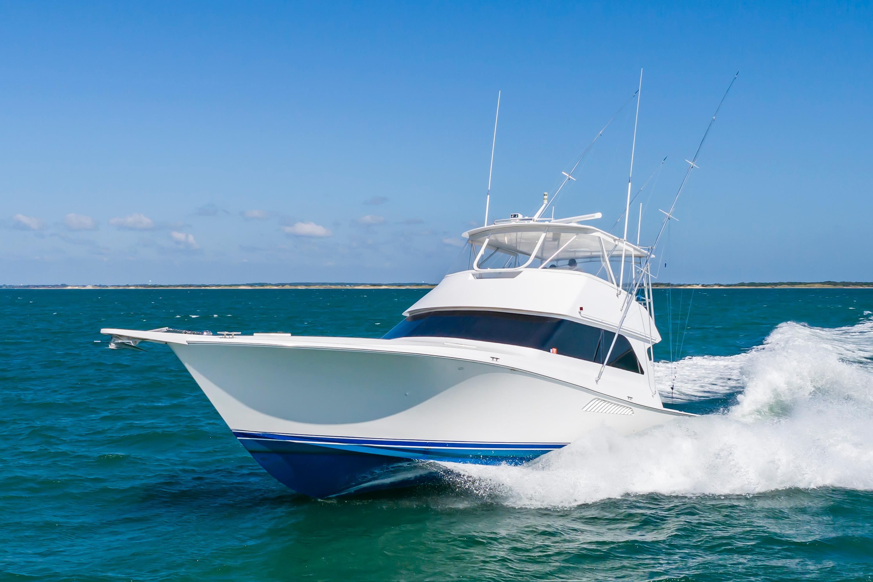 Slide: The Image of 1998 Viking Convertible yacht cruising on open water. - 8
