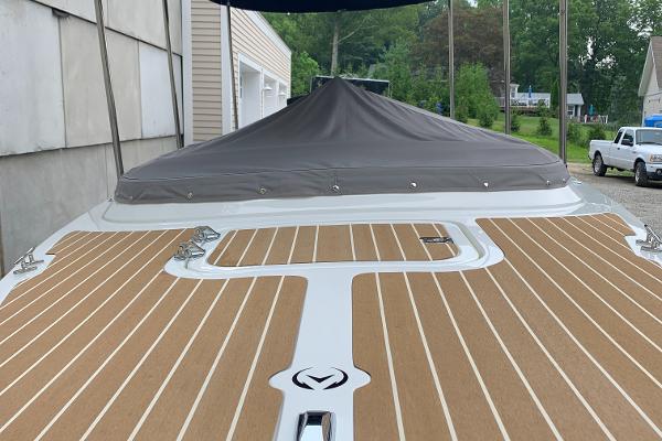 Slide: The Image of 2023 Vision Marine Technologies Fantail 217 boat with covered deck and wood-like flooring. - 14