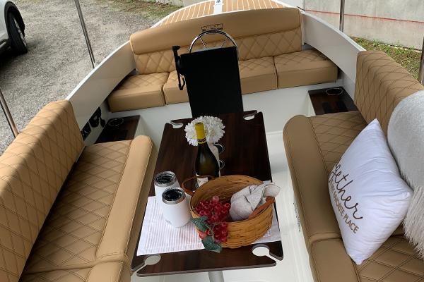 Slide: The Image of 2023 Vision Marine Technologies Fantail 217 boat interior with tan seating and a dining setup. - 3