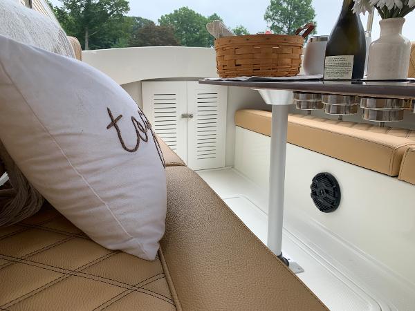 Slide: The Image of 2023 Vision Marine Technologies Fantail 217 interior with tan seating and picnic setup. - 6