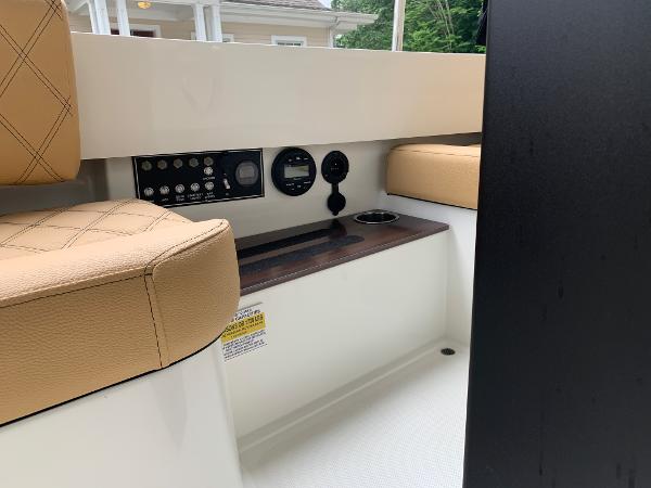 Slide: The Image of 2023 Vision Marine Technologies Fantail 217 boat interior with control panel and beige seating. - 9