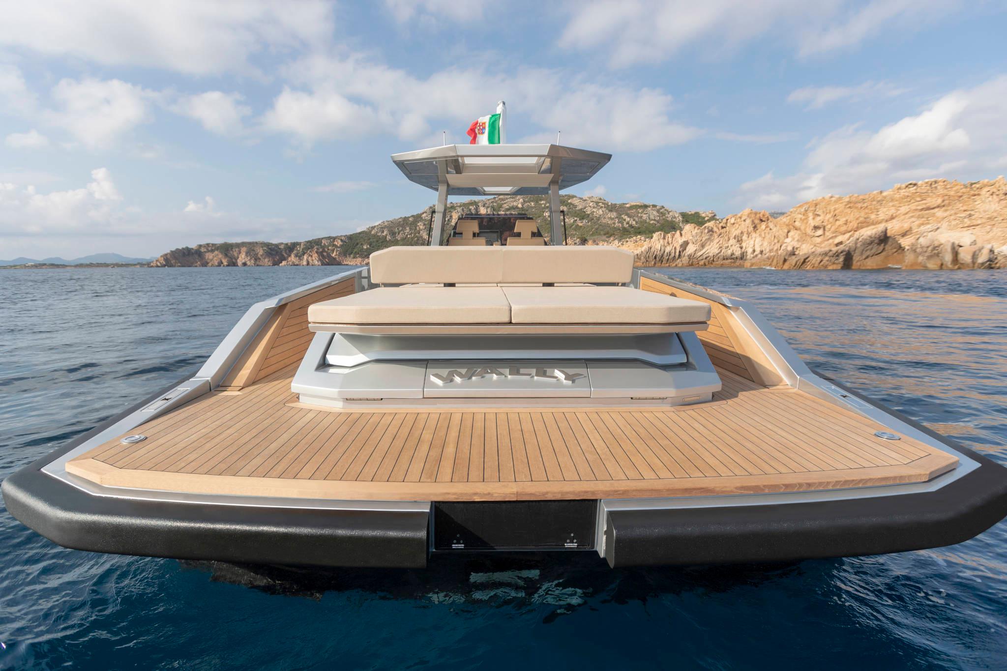 Slide: The Image of 2023 Wally WallyTender48 luxury yacht on calm sea with scenic rocky coastline. - 2