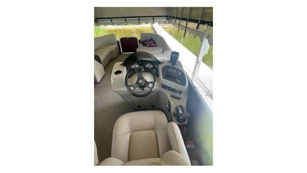 Slide: The Image of 2016 Weeres Pontoons ECLIPSE 240TT interior with steering console and seating. - 12