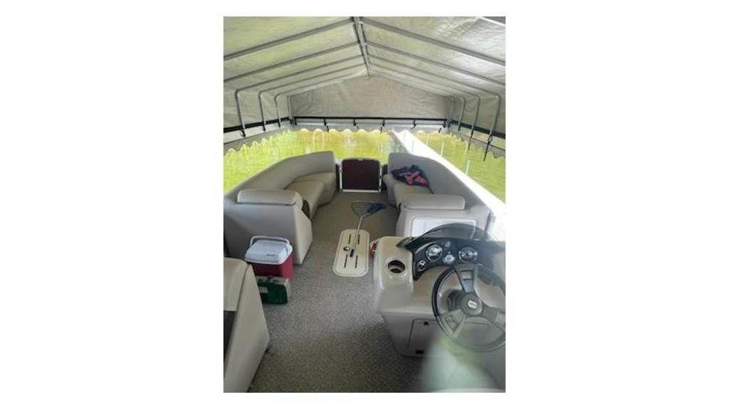 Slide: The Image of 2016 Weeres Pontoons ECLIPSE 240TT interior with canopy, seating, and steering console. - 15