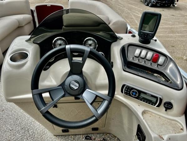 Slide: The Image of 2016 Weeres Pontoons ECLIPSE 240TT dashboard with steering wheel and control panel. - 8