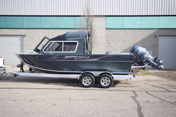 Slide: The Image of 2023 Weldcraft 210 Revolution F200XB boat on trailer, side view. - 0