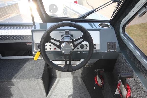 Slide: The Image of 2023 Weldcraft 210 Revolution F200XB boat dashboard and steering wheel. - 12