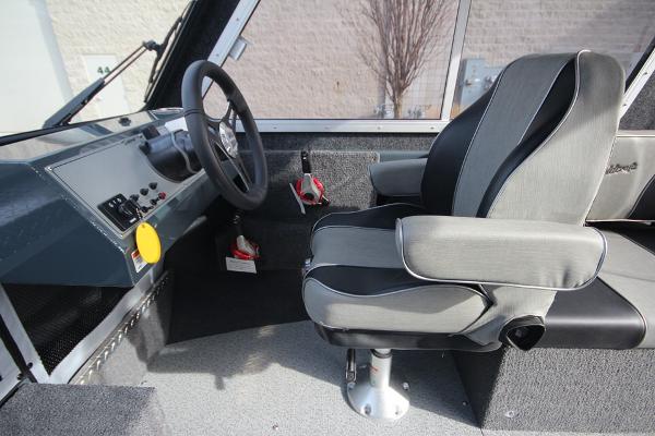 Slide: The Image of 2023 Weldcraft 210 Revolution F200XB boat interior with captain's seat and steering console. - 28