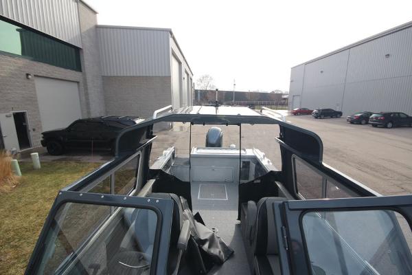 Slide: The Image of 2023 Weldcraft 210 Revolution F200XB boat in stock, parked outside industrial buildings. - 31