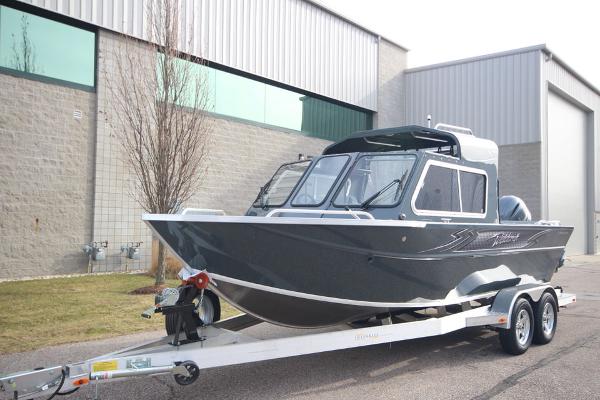 Slide: The Image of 2023 Weldcraft 210 Revolution F200XB boat on trailer outside industrial building. - 34