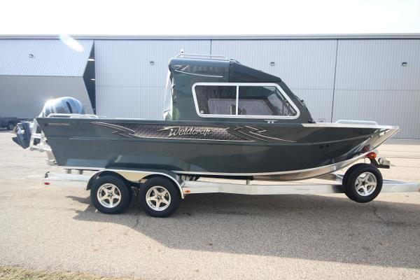 Slide: The Image of 2023 Weldcraft 210 Revolution F200XB boat on trailer, side view. - 4