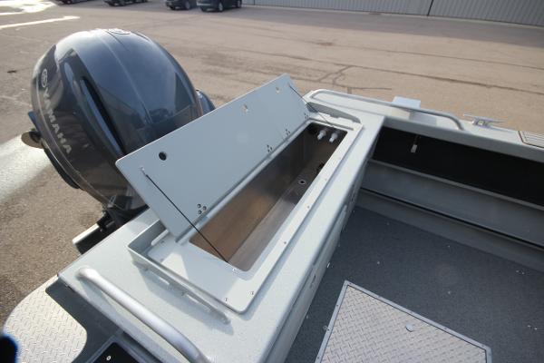 Slide: The Image of 2023 Weldcraft 210 Revolution F200XB boat with open storage compartment and Yamaha outboard motor. - 9