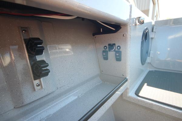 Slide: The Image of 2026 Weldcraft 220 Ocean King 250XB interior detail with control panel and storage compartment. - 15