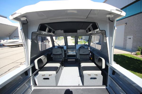 Slide: The Image of 2026 Weldcraft 220 Ocean King 250XB boat interior with seating and windows. - 17