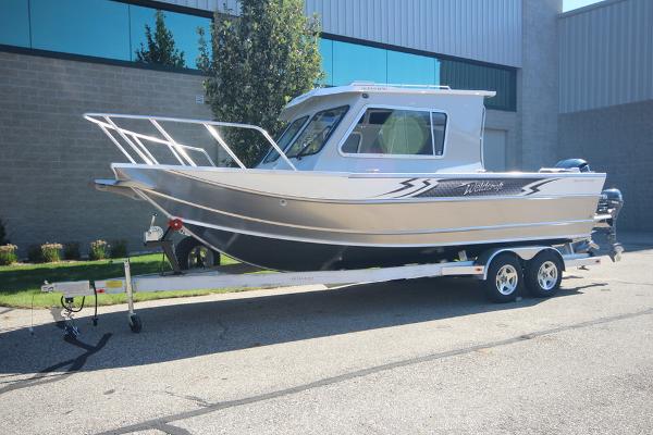 Slide: The Image of 2026 Weldcraft 220 Ocean King 250XB boat on trailer, parked outdoors. - 2