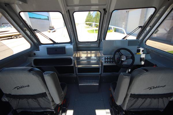 Slide: The Image of Interior of 2026 Weldcraft 220 Ocean King 250XB boat, featuring dual seats and steering console. - 20