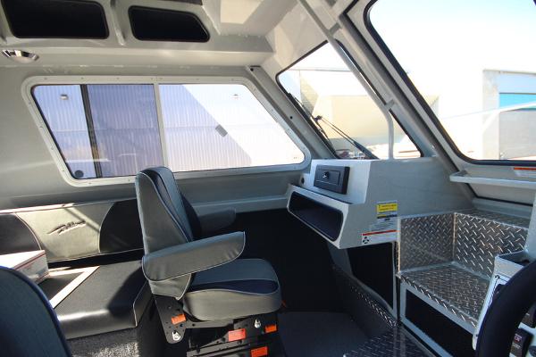 Slide: The Image of Interior of 2026 Weldcraft 220 Ocean King 250XB boat with modern seating and controls. - 21